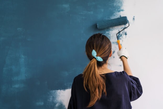 Lady painting wall | Homespun